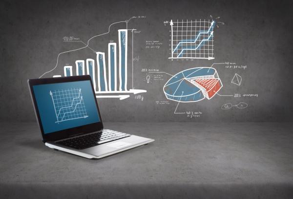 laptop with pie chart and bar graph in the background