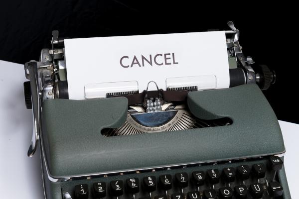 typwriter with a piece of paper with the word "cancel"