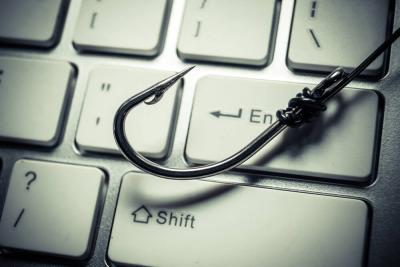 gray fishing hook on top of a white keyboard